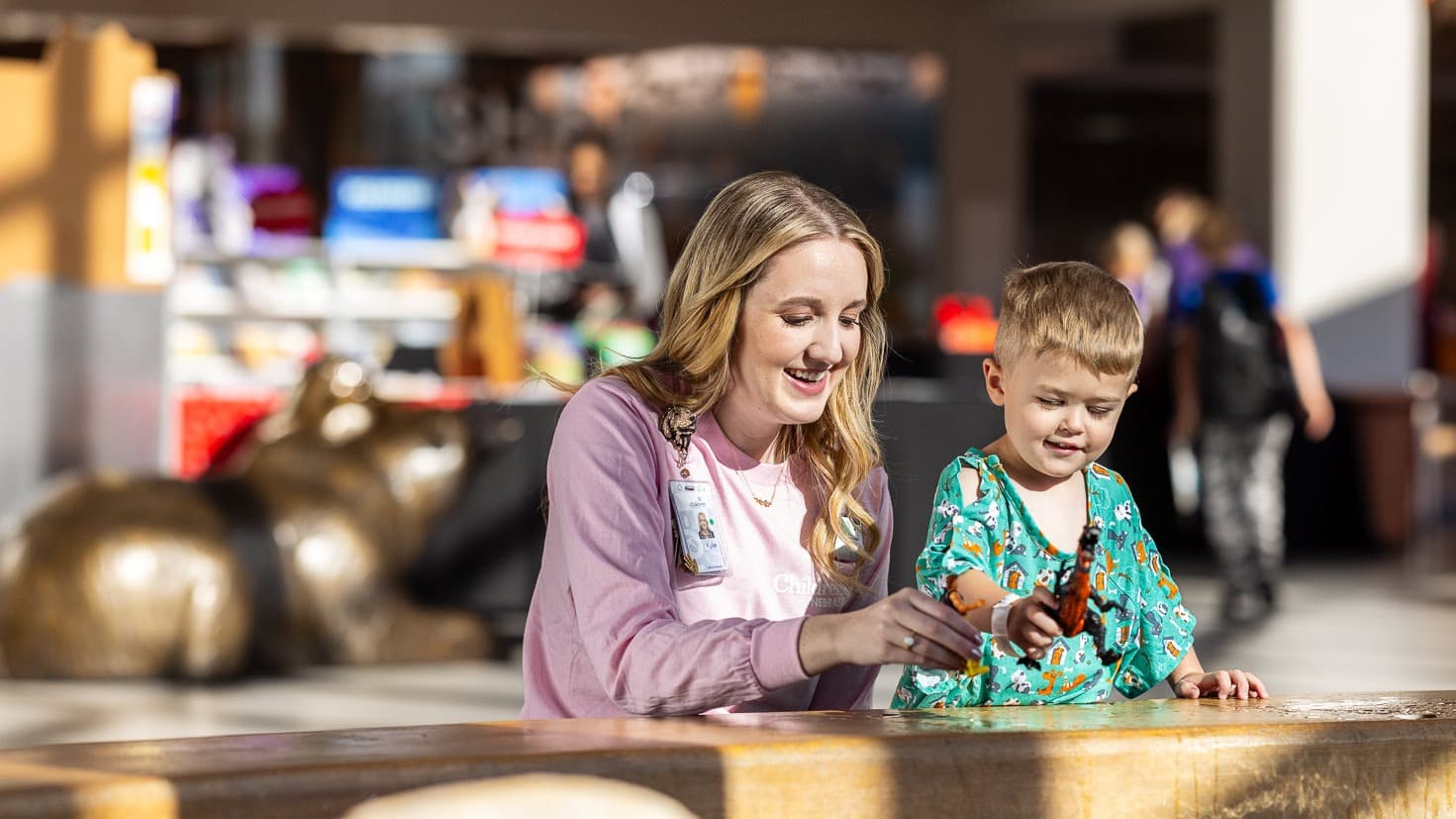 Children's Nebraska provider playing dinosaurs with young patient