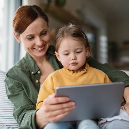 Mother and daughter looking at tablet